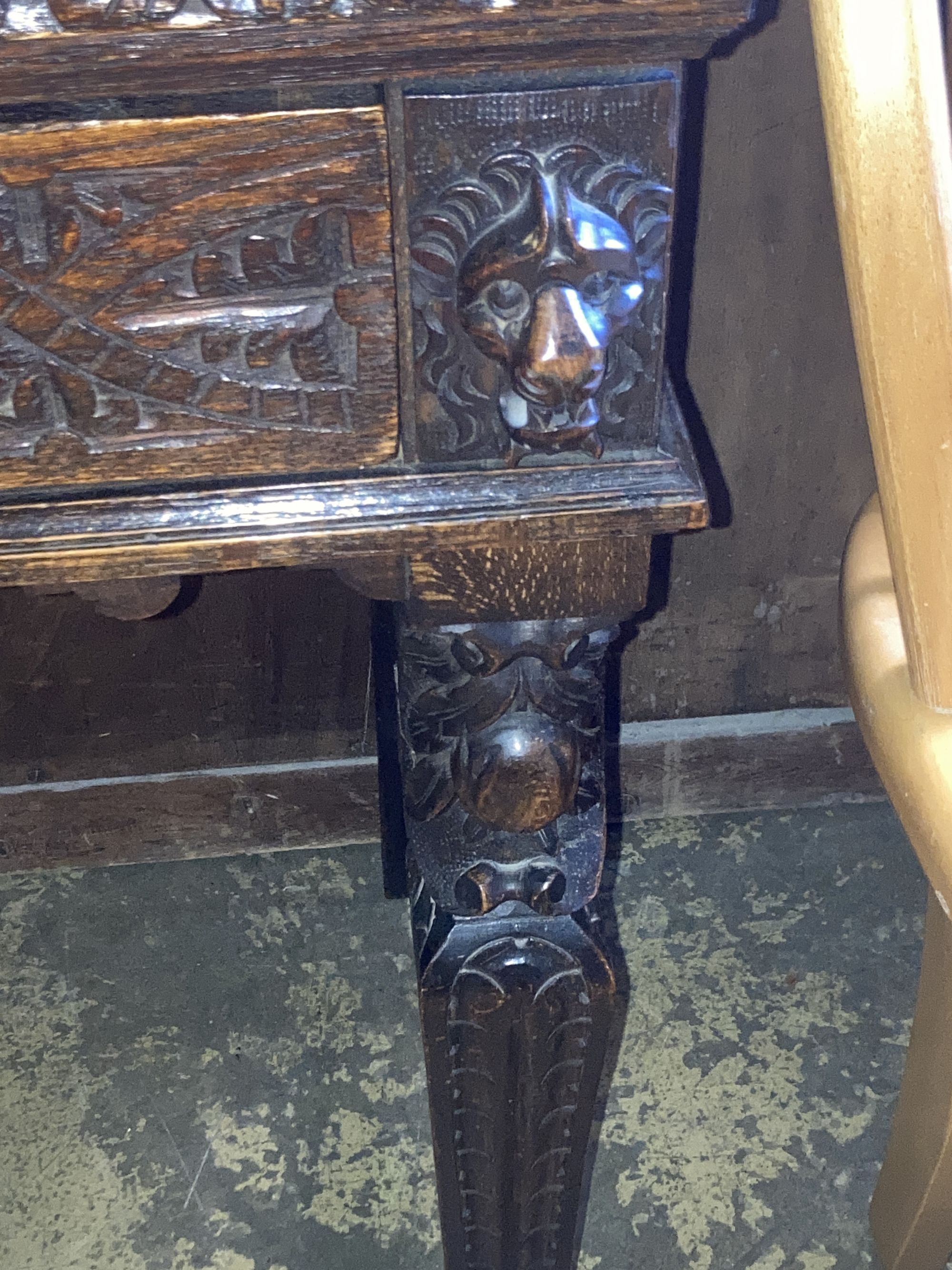 A late 19th century Flemish carved oak side table, width 88cm, depth 42cm, height 76cm, together with a carved oak spinning chair